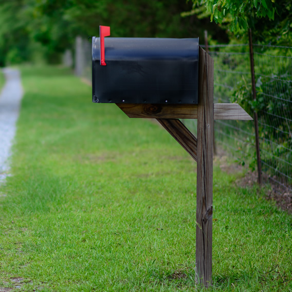 Black mailbox in a residential area.